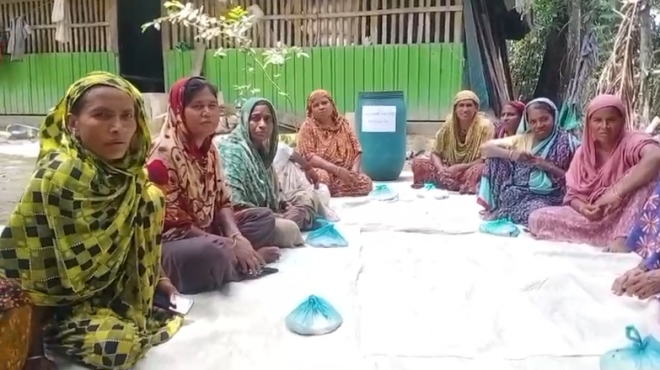 Women participating in a community-led food bank meeting